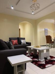 a living room with a couch and a table at Rehoboth Homes in Port Harcourt