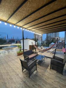 a patio with benches and a hammock and a swing at Terrace House Near Opera in Tbilisi City