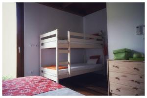 a bedroom with two bunk beds and a dresser at Gêres! Caniçada House! in Geres