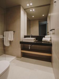 a bathroom with a sink and a mirror at Hotel Llane Petit in Cadaqués