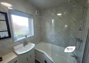 a bathroom with a shower and a sink and a tub at Luke Stays - Chilside Road in Felling