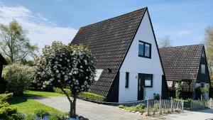 una casa en blanco y negro con techo negro en Sternkieker en Kappeln