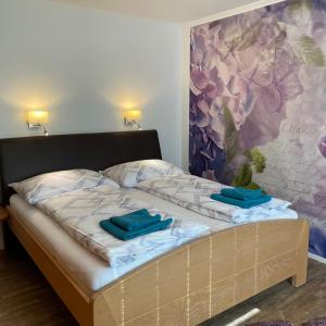 a bed with two blue towels on top of it at Ferienwohnung Brandmaier in Unken