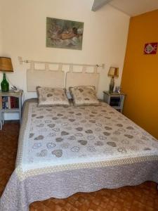 a bedroom with a large bed with two pillows at Neptuna- 52B- Appart spacieux- 7 pers in Cap d'Agde