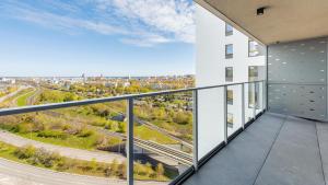 an apartment balcony with a view of a highway at Apartamenty Sun & Snow Modern Tower in Gdynia