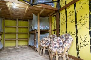 a room with two chairs and a bunk bed at Kalitusi Nature Resort in Fort Portal +49 photos