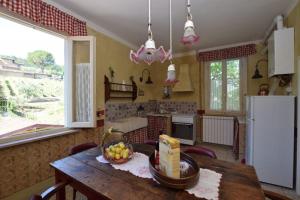 a kitchen with a table with a bowl of fruit on it at Bello Stare by PosarelliVillas in Cantagrillo