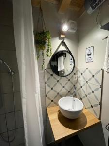 a bathroom with a sink and a mirror on a counter at La maison du bonheur "Le petit Four" in Saint-Ouen-sous-Bailly