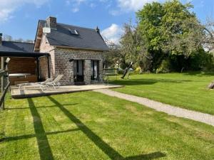 una casa con un patio de césped con un camino en La maison du bonheur "Le petit Four", en Saint-Ouen-sous-Bailly