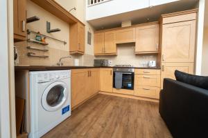 a kitchen with a washer and dryer in a room at Luxury 2 Bed Apartment – Near Heathrow, Legoland, Windsor Slough in Slough