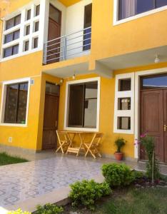 Bonita casa acogedora في كوتشابامبا: مبنى أصفر مع طاولة نزهة أمامه