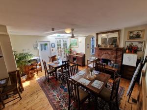 una sala da pranzo con tavoli, sedie e camino di Black Horse Canterbury a Canterbury