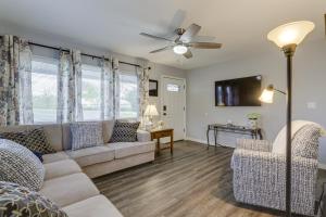 a living room with a couch and a ceiling fan at Cozy Kentucky Retreat - Deck, Near Ark Encounter! in Dry Ridge