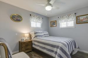 a bedroom with a bed and two windows at Cozy Kentucky Retreat - Deck, Near Ark Encounter! in Dry Ridge