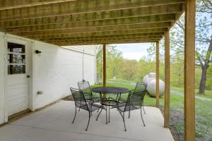 a patio with a table and chairs on it at Cozy Kentucky Retreat - Deck, Near Ark Encounter! in Dry Ridge