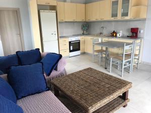 a living room with a couch and a table in a kitchen at Loy Loy House 2 in Koilás