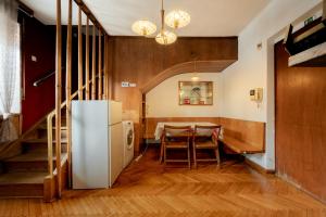 a kitchen and dining room with a table and a refrigerator at Pi House in Ljubljana