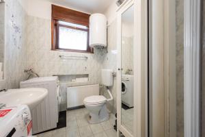 a white bathroom with a toilet and a sink at Pi House in Ljubljana +85 photos