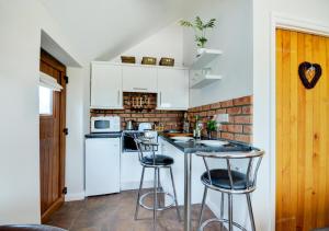 a kitchen with a counter and two bar stools at Badger Set in Cantley