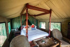 a bedroom in a tent with a bed in it at Inyala Game Lodge in Ventersdorp +91 photos