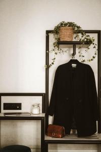 a black jacket hanging on a shelf in a room at La Maison Montparnasse in Paris