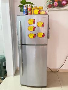 a stainless steel refrigerator with stickers on it at D'Zara Homestay in Sepang