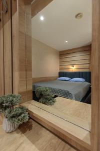 a bedroom with a bed and two potted plants at Apart & Rooms Fotinov in Burgas City