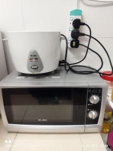 a mixer sitting on top of a microwave at D'Zara Homestay in Sepang