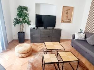 a living room with a couch and a tv at Cicibela Apartment - Zadar in Zadar