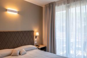 Postel nebo postele na pokoji v ubytování Hotel Boston