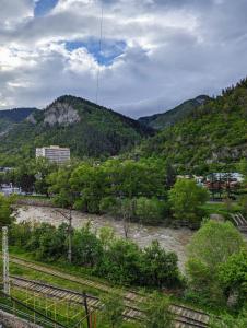 a view of a river with mountains in the background at Gari's apartment next to Borjomi Central Park in Borjomi