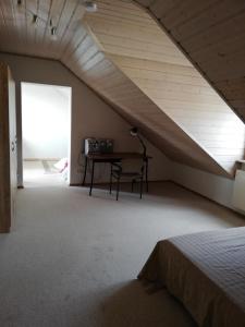a attic room with a table and a bed at Sonniges Fleckchen in Griesheim