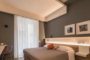 a bedroom with a large bed and a window at Bed In Centro in Naples