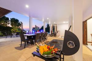 a grill with a table and chairs on a patio at Villa Wassana - Sunset View 5Bed in Koh Samui 