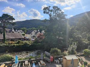 a view of a village with mountains in the background at Ystafell Gelert Room in Beddgelert