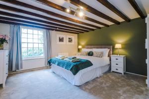 a bedroom with a large bed and a large window at Cheshire Countryside, Delamere Forest, Family Retreat Rose Cottage in Kelsall