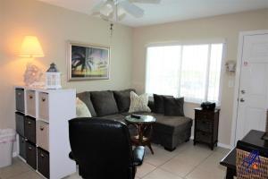 a living room with a couch and a chair at Tropic Breeze 17 in St. Pete Beach