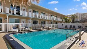 a swimming pool in front of a hotel at Tropic Breeze 17 in St. Pete Beach