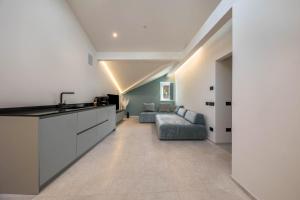 a kitchen and living room with a couch and a sink at App 302 Palazzo Cavour in Bolzano +15 photos