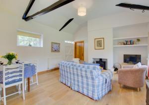 a living room with a couch and a table and chairs at Dockings Cottage in Hindringham