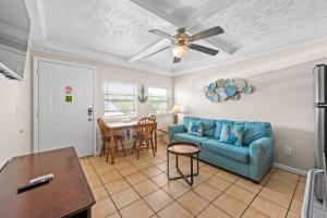 a living room with a blue couch and a table at Great Location 1BR Pool Parking Pets Allowed 5 in Myrtle Beach