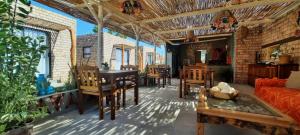 a living room with a couch and a table and chairs at The Desert House in Uis