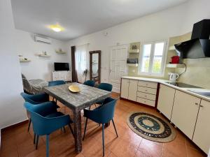 a kitchen and dining room with a table and chairs at Family Villages Santorini in Vlychada Beach