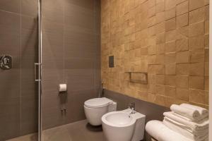 a bathroom with a toilet and a sink at Bed In Centro in Naples