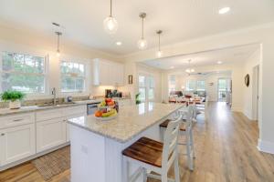 a kitchen with white cabinets and a island with a counter top at New Bern Vacation Rental on Farm with Fire Pit! in New Bern