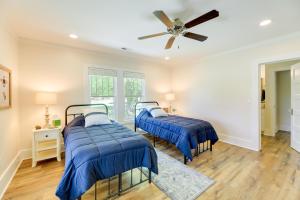 two beds in a room with a ceiling fan at New Bern Vacation Rental on Farm with Fire Pit! in New Bern