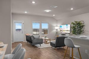a living room with two chairs and a table at @ Marbella Lane - Amazing 4BR Lakeview Home in Austin