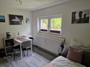 a room with a bed and a table and a window at Tinyroom mit Ausblick in Königstein an der Elbe