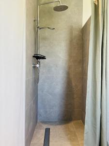 a shower in a bathroom with a shower curtain at Greene Acres - Room Only in Doolin