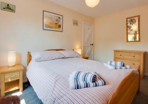 a bedroom with a bed with two pillows on it at East Cottage in Corpusty